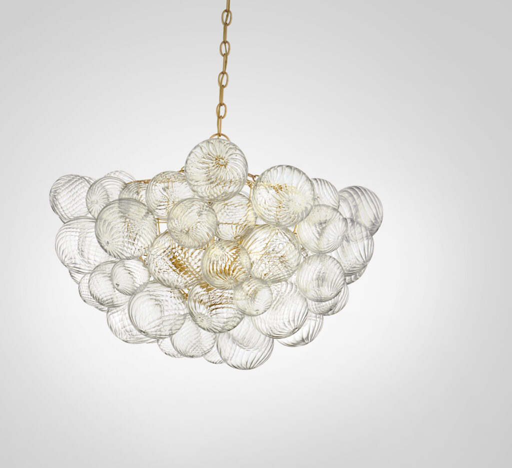 swirling artisanal glass globes attached to a gleaming metal basket.