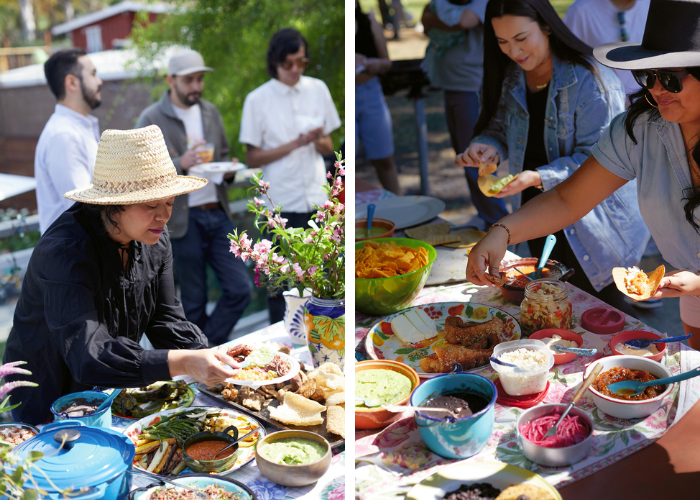 people gather around and serve themselves from a table filled with Mexican food