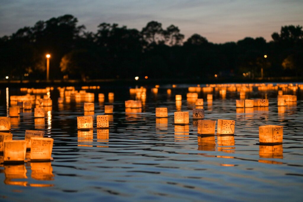 paper lanterns sit on water. events in pittsburgh