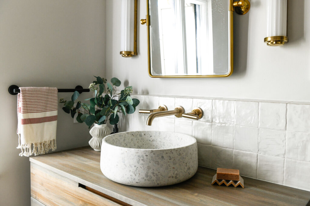 Amanda Boch's Bathroom Redesign. A marble bowl sink on a wooden vanity