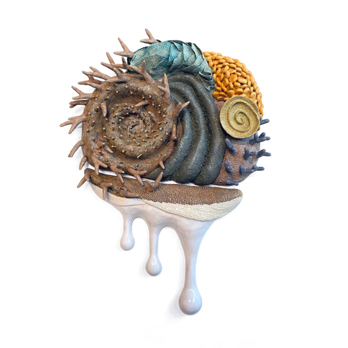 a piece of art made of glazed stoneware and porcelain, featured in contemporary craft's Climate Awakening: Crafting a Sustainable Future. brown, green, orange spikes on top with white dripping from the bottom
