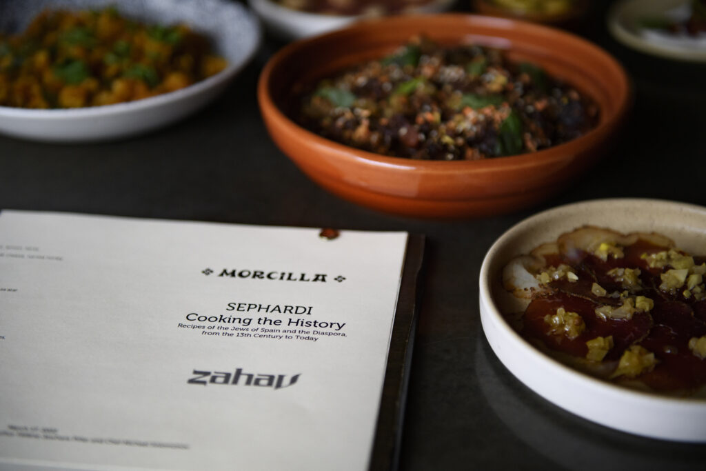 A menu and two plates of sephardic food