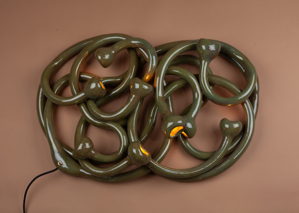 The Large Wall Squiggle is made from more than 30 feet of extruded stoneware and features nine bulbs in what look like the mouths of lampreys. It is available in various finishes.