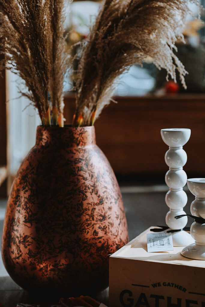 A cool shaped vase with feathery leaves, fall home decor