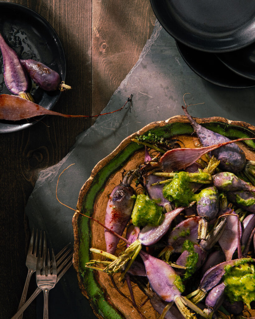 An aerial shot of a plate of Roasted Radishes with Garlic Scape Butter. fall recipe