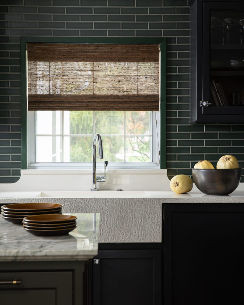 April Spagnolo's Custom stone sink surrounded by green title. 