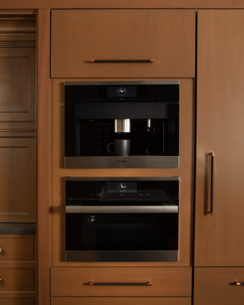 April Spagnolo's kitchen appliances set in brown cabinets.
