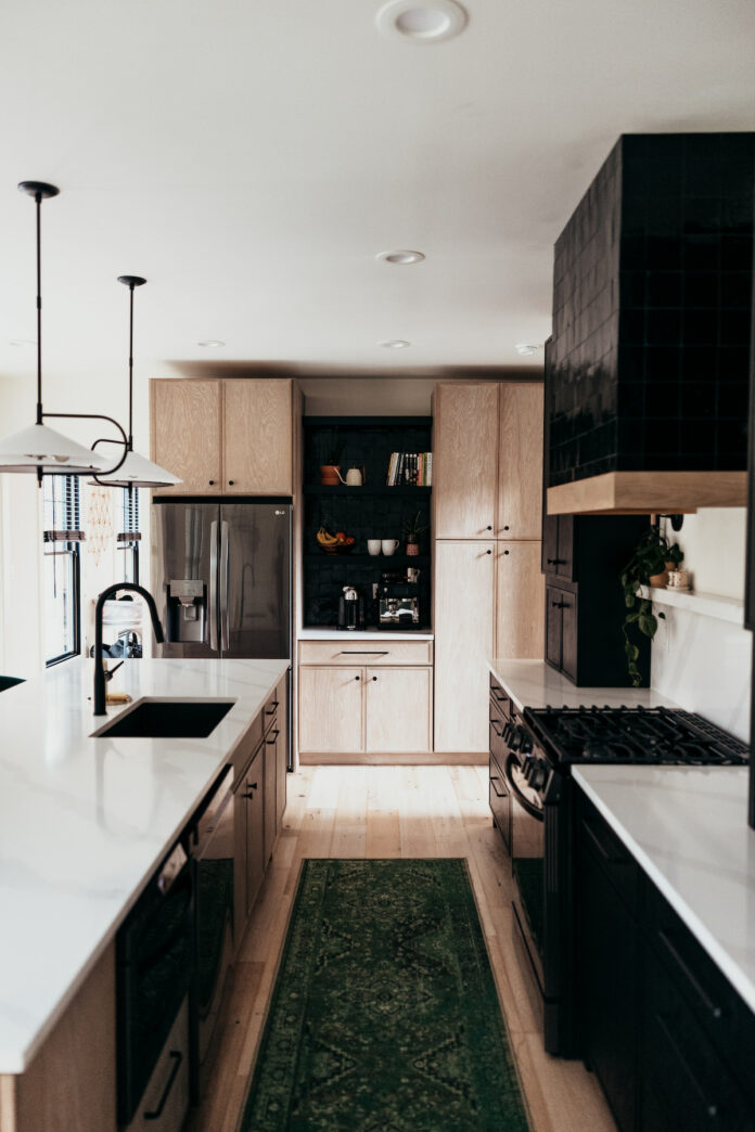 A brown and black kitchen from DB Design Center