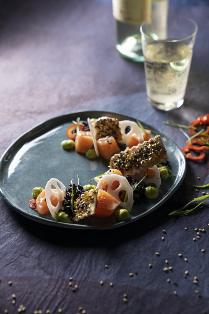 Exquisite Salmon Poke Infused with Yuzu, Truffled Yuzu Kosho Sauce, Spicy Avocado Purée, and Crispy Rice Cracker