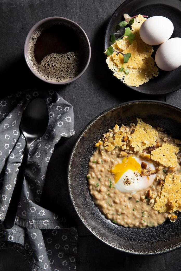 Savory Squash & Chestnut Porridge in a skillet with a napkin and spoon on the side