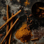 homemade pumpkin spice recipe lays spread out on a table next to cinnamon sticks