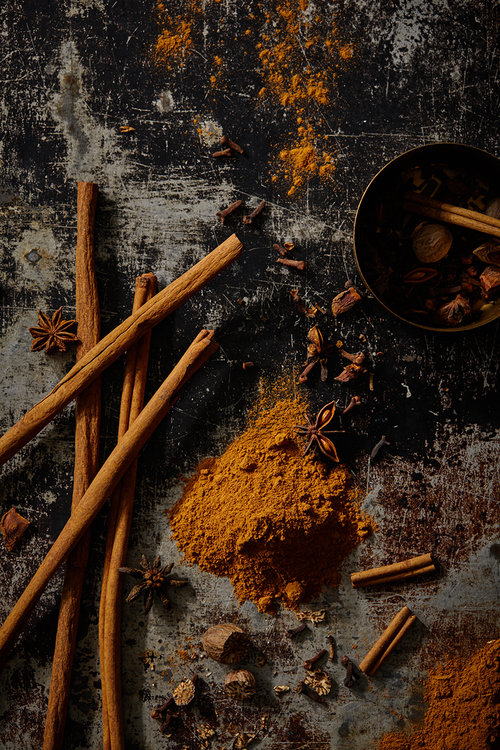 homemade pumpkin spice recipe lays spread out on a table next to cinnamon sticks