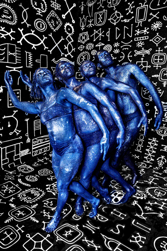 Pittsburgh rainbow serpent group poses while covered head to tow in blue. they lean to the left with one arm up