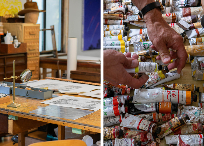 on the left, a work station for an artist. on the right, tons of paint tubes with a pair of hands overtop