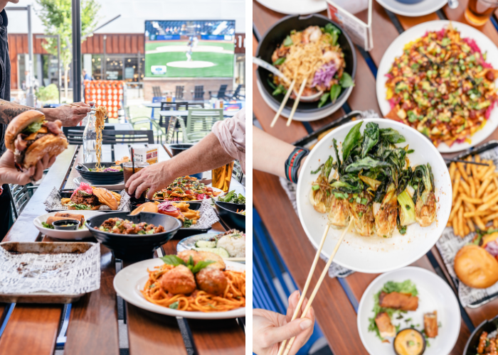 Food from City Kitchen Pittsburgh. Many hands dig into various plates sitting on a table