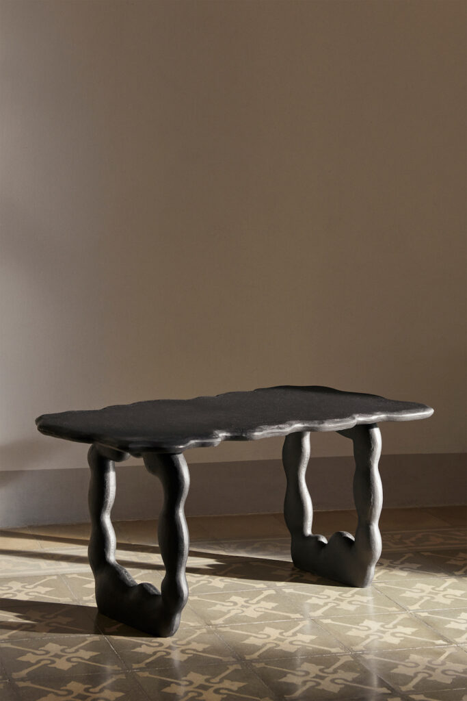 A black wavy looking bench