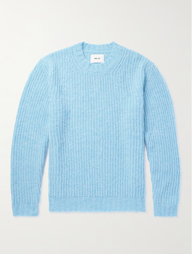 a light blue cable knit sweater