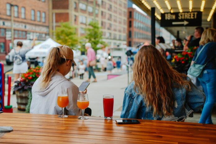 Two people enjoy drinks outside at a table in The Terminal.