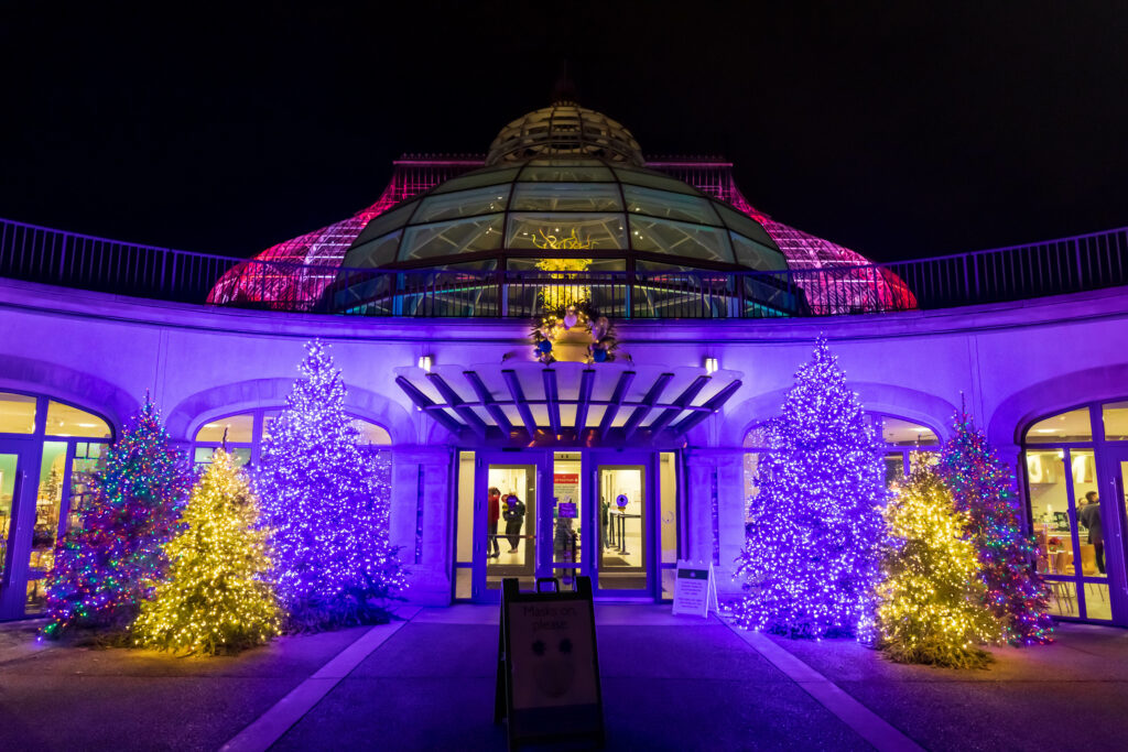 Exterior of Phipps Conservatory and Botanical Gardens covered in purple lights