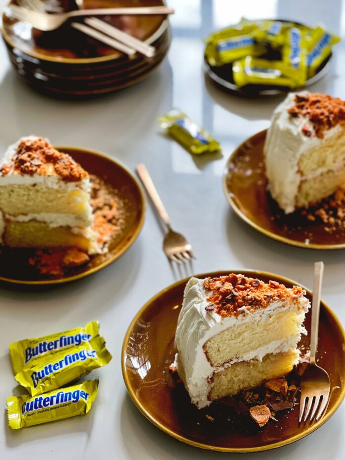 Three peices of Rum Buttermilk Butterfinger Cake sit on three separate plates.