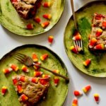 Three green plates with slices of Candy Corn Blondies on top.