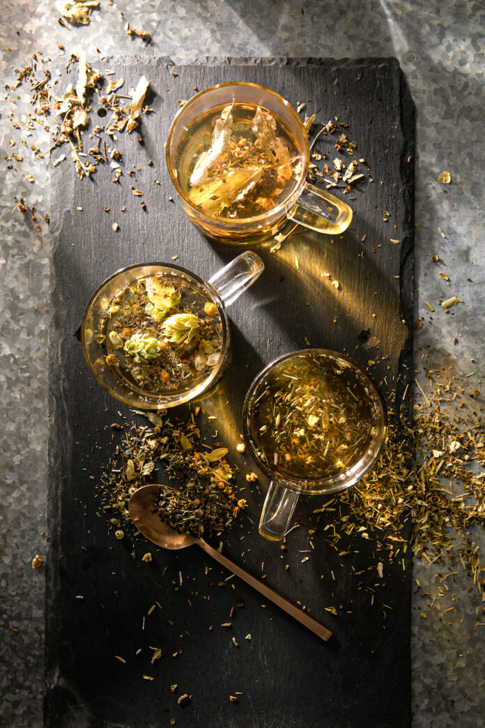 an aerial view of three cups of tea, golden in color. nerve-calming natural remedies