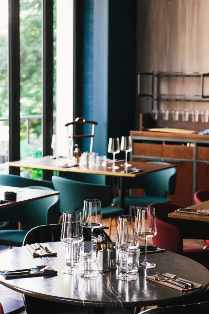 The interior of a restaurant, multiple wine glasses sit on the tabletop. Pittsburgh Food News