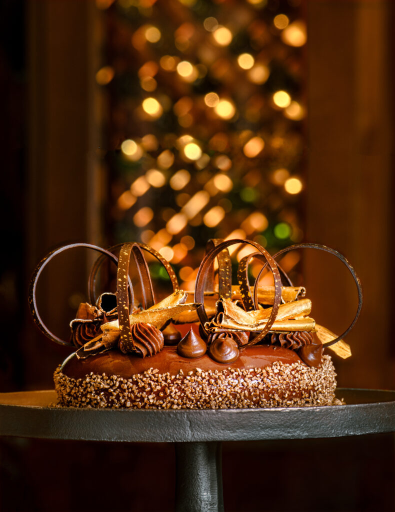 A decadent chocolate cake with elaborate chocolate toppings and decor.