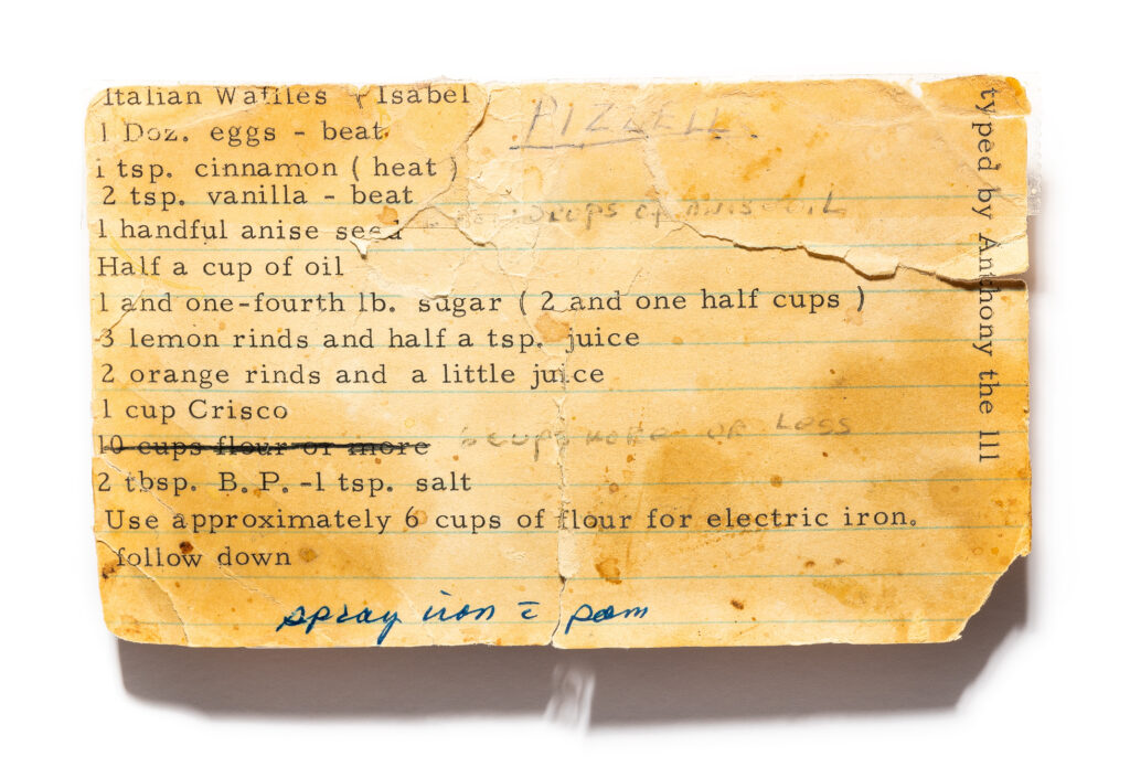 A recipe card that's old and weathered with a Pizzelle recipe on it