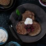 Delectable griddle cakes made with buckwheat flour, topped with a flavorful blackberry sauce infused with bay leaf and black peppercorns.