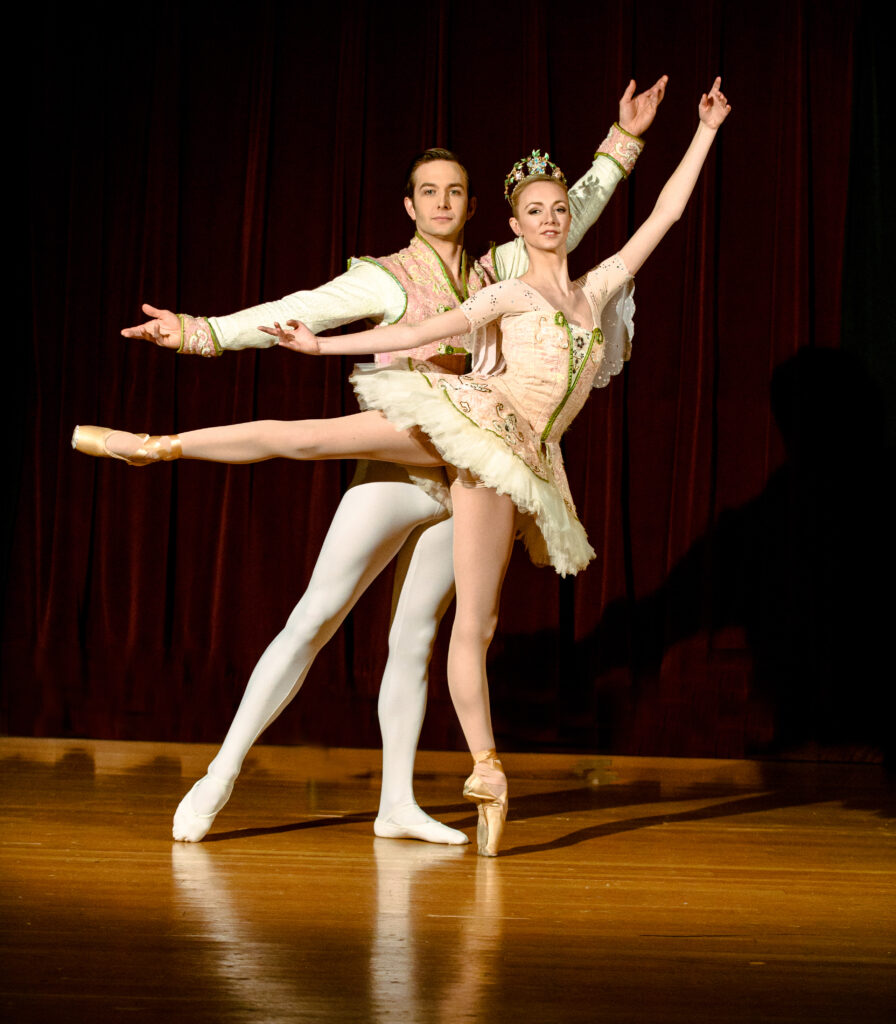 Male and female ballet dance partners in costume, posing for a picture