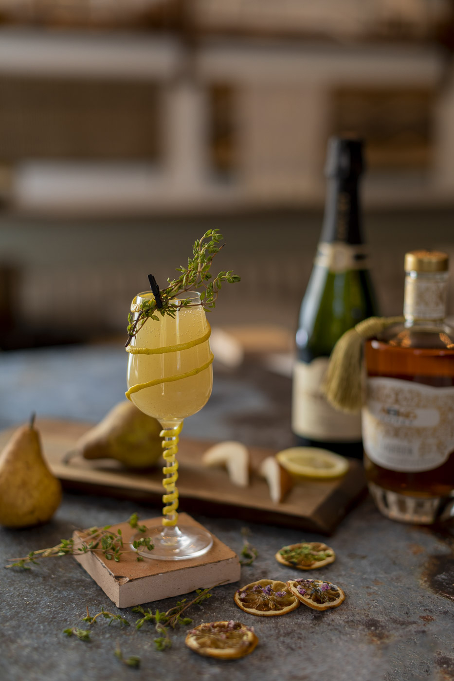 Rainy Day Bubbles cocktail with lemon twist and thyme bundle garnish
