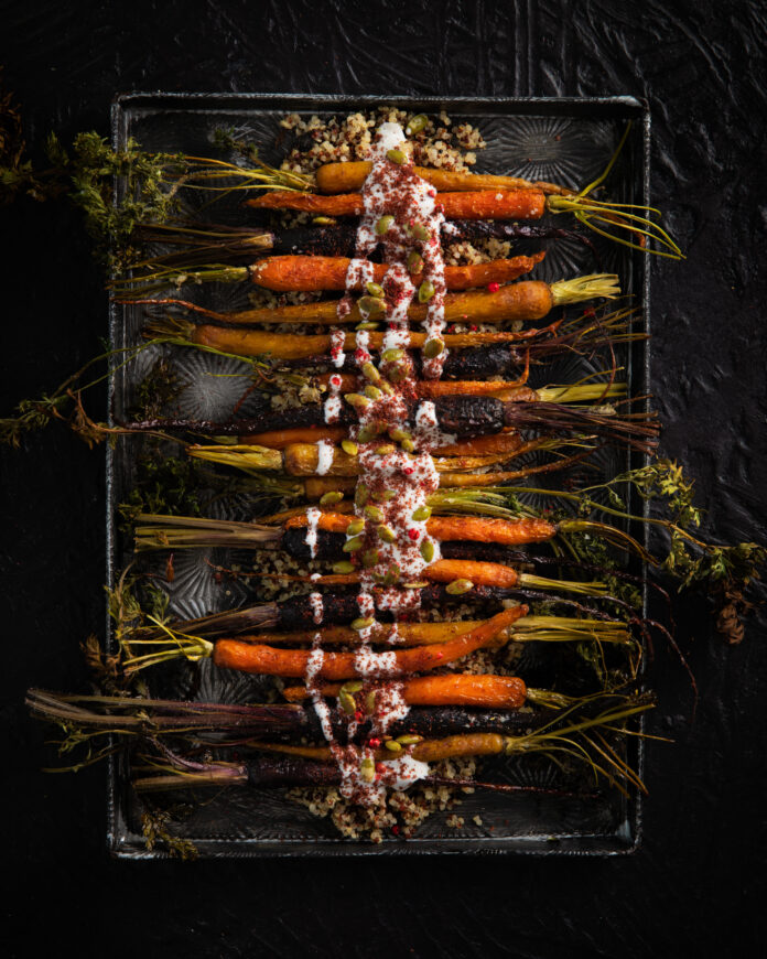 Sheet Pan roasted carrots with tahini Sheet Pan roasted carrots served on a black tray with Tahini sauce