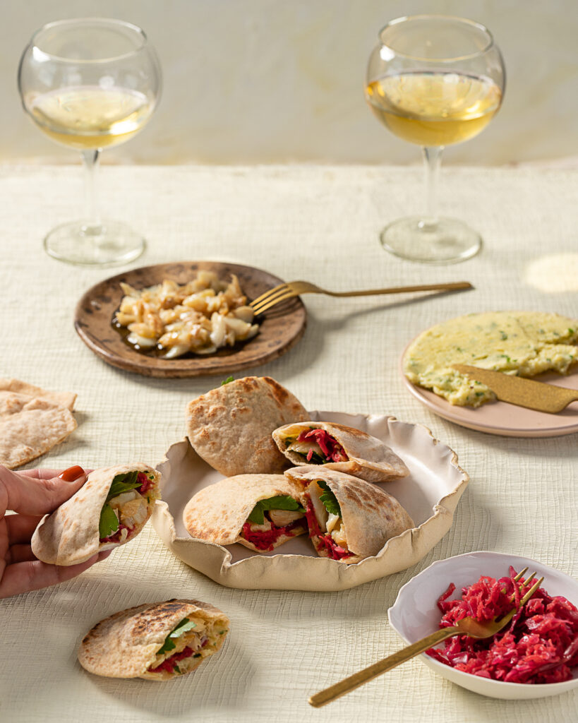 Whole-Grain Pita, accompanied by a bottle of Garalis Terra Ambera Muscat of Alexandria from Lemnos, Greece. A Mediterranean delight featuring fermented beets and a delectable skordalia, embodying the rich flavors of Greek cuisine.