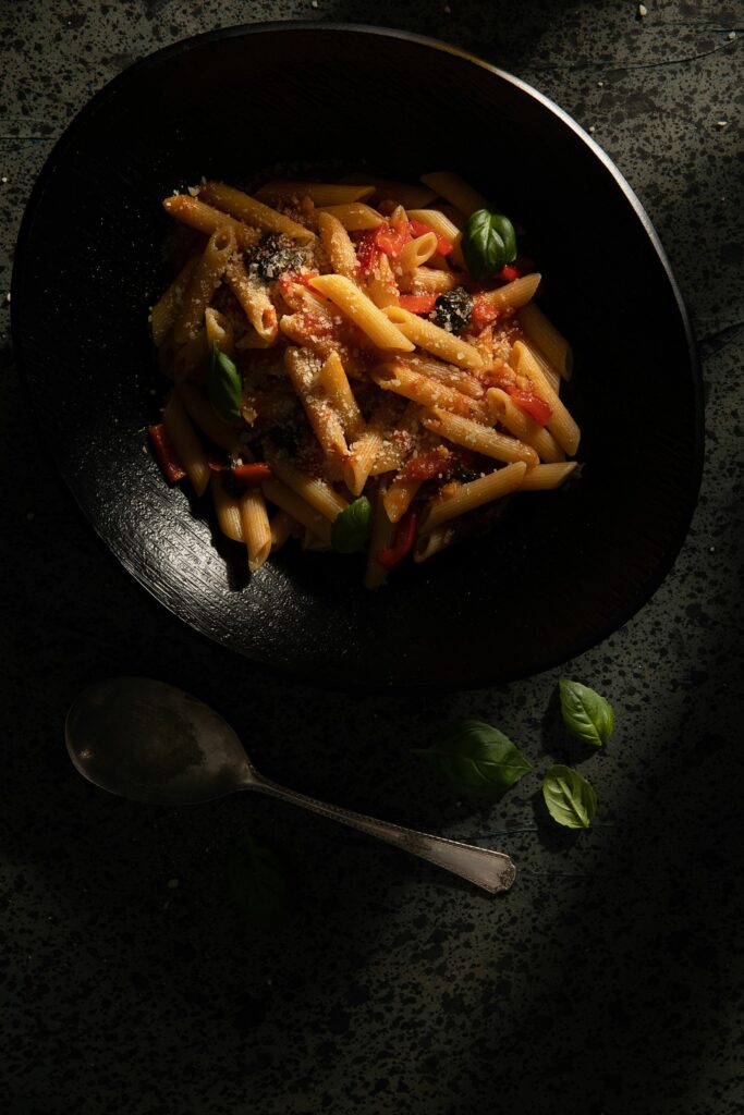 A dish of Hugo's Favorite Marinara Sauce pasta in a black bowl made by Victoria Sande.