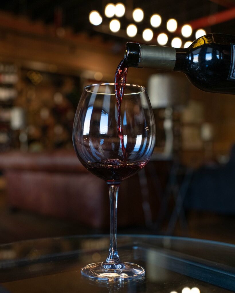 A bottle of wine pouring into a wine glass at the eatery at Pittsburgh's The PA Market.