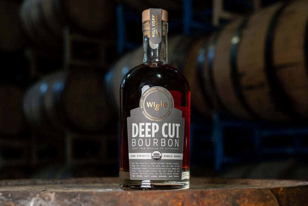 A look-in picture of a bottle of Wigle Whiskey Deep Cut Bourbon with a dark background.