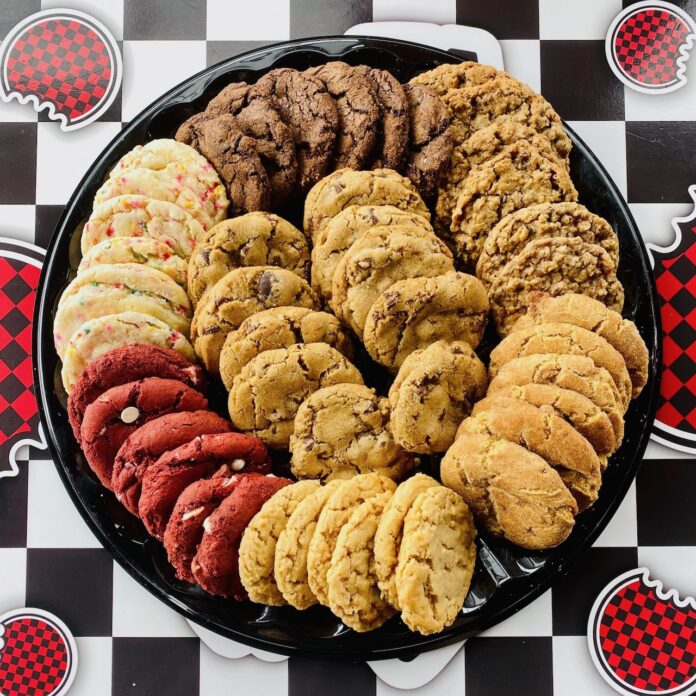 A platter of cookies laid out in a circle on a checkered table.