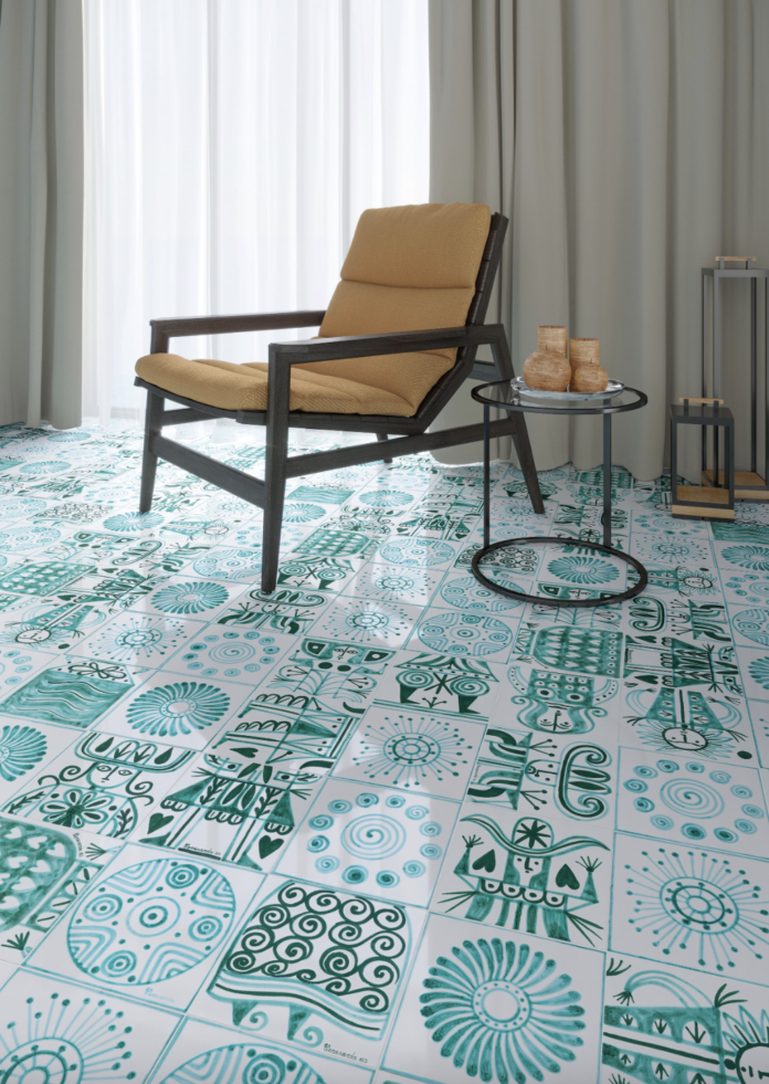 recapping cersaie 2023 Hand painted teal and white tiles sit beneath a simple brown chair and minimalist table.