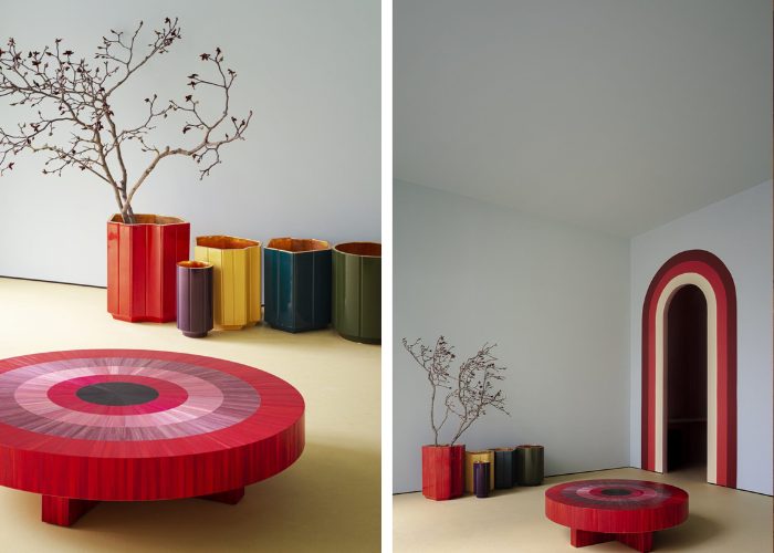 Two side by side photos of a red, low, spiral table with colorful plant pots and a colorful archway in the background.