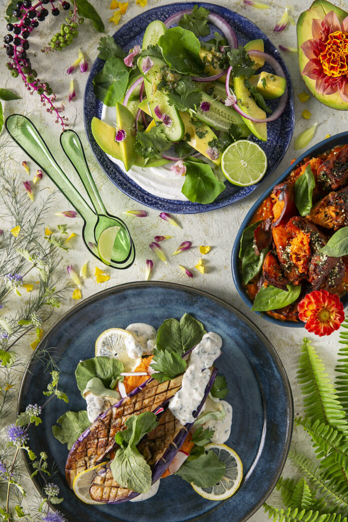 Veggie Forward Side Dishes: Cucumber salad, crispy sweet potatoes, and improv eggplant served in different plates