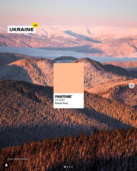 A photo of a Ukrainian sunset over a set of mountains with a photo of the pantone color of the year peach fuzz swatch in the middle.