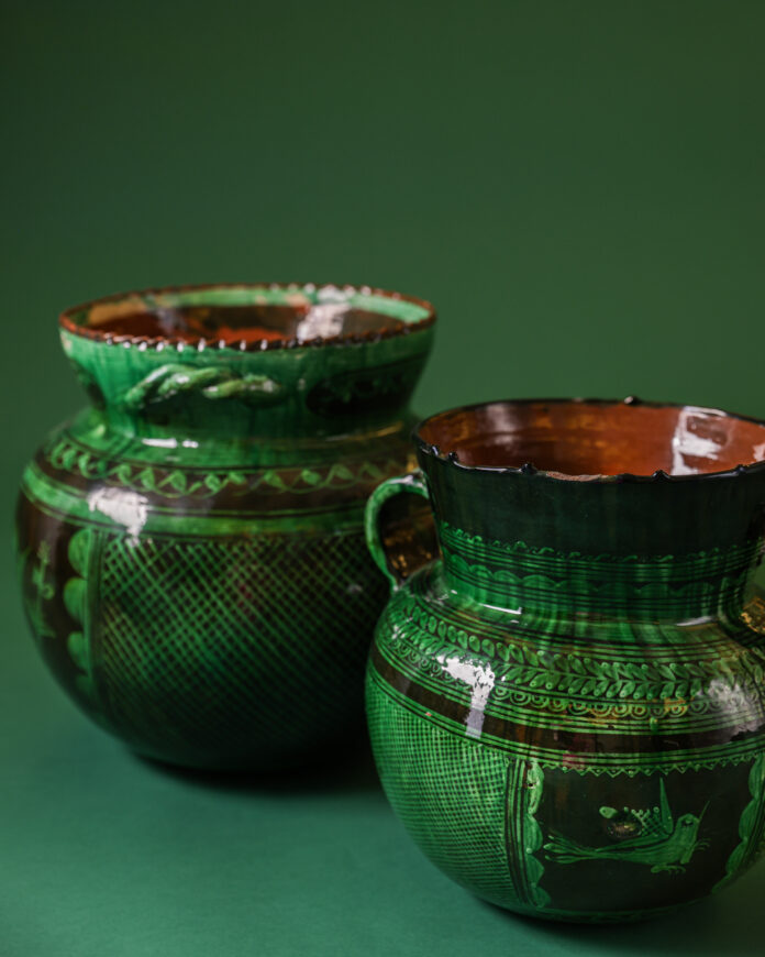 Curator Kate Macuen showing rare ceramics in MOIFA vault to visitors