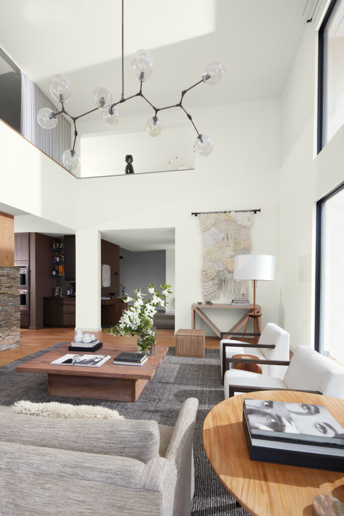 A living room with a beige eggshell white spring painted wall, fully furnished.