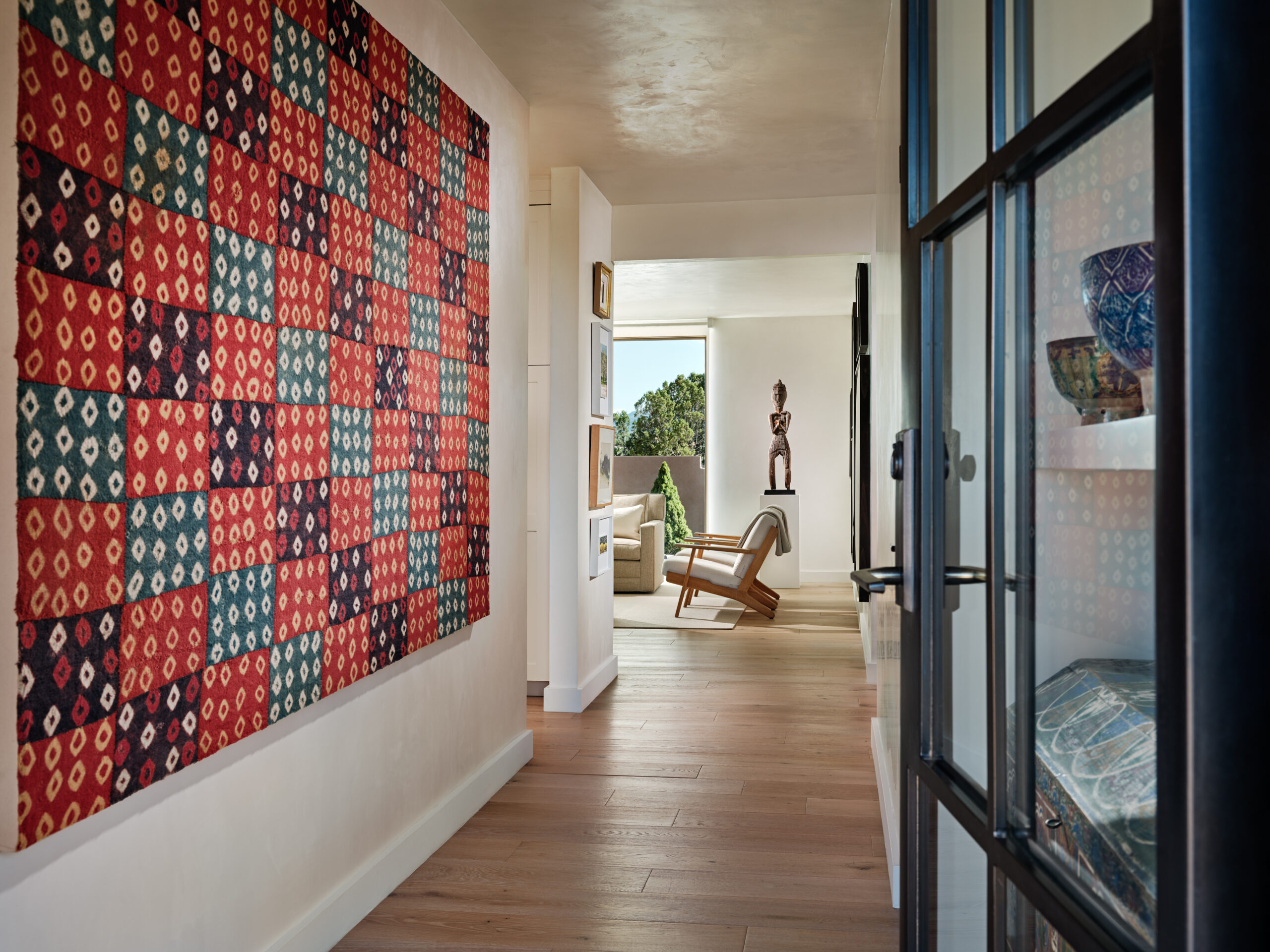 A delectable Peruvian textile brings light and color to a hallway.