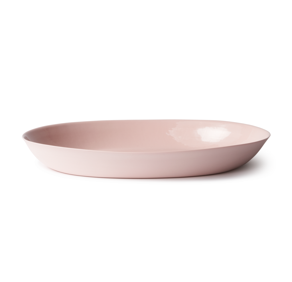A baby pink serving tray sits on a white background.