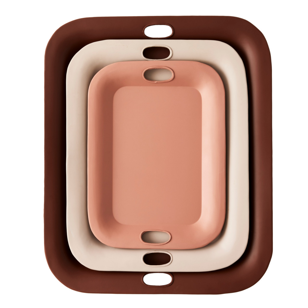 Three servings trays are stacked on top of each other in the colored dark brown, beige, and light pink