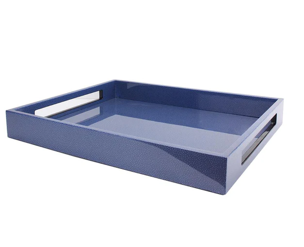 A blue slotted serving tray reflects light against a white background.