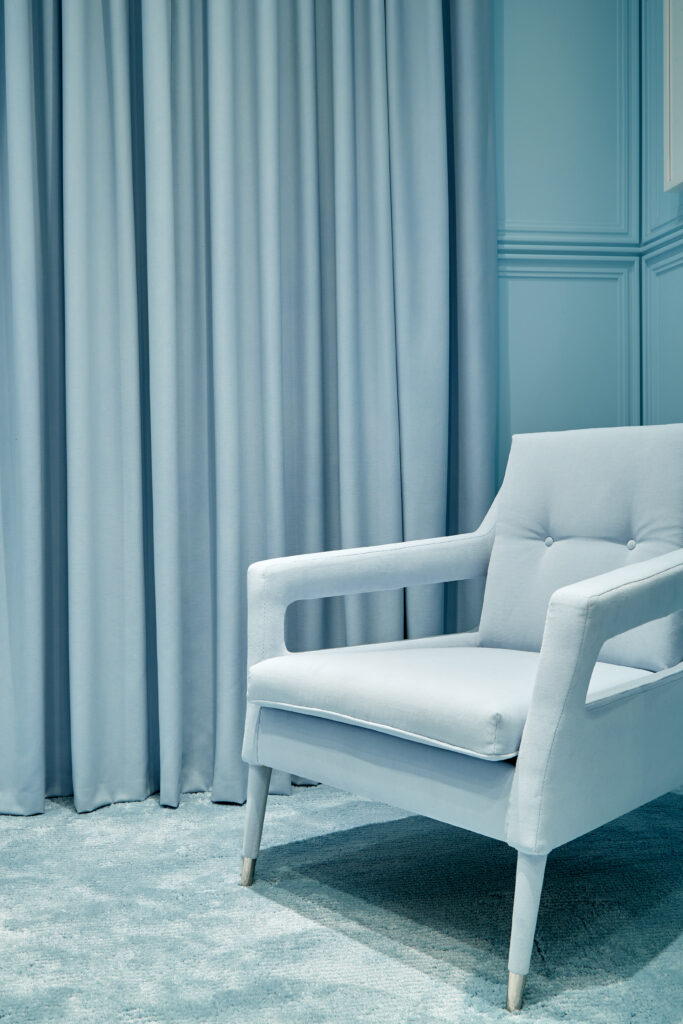 Shown here: Munna Chantal armchair with polished nickel feet covers, upholstered in Creation Baumann. The curtain is Maharam's Valor in color Alfresco