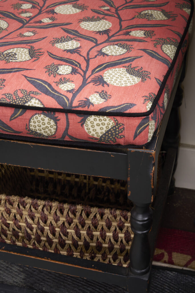 A chair with a red fabric featuring black thistles over it from Paris Design Week.